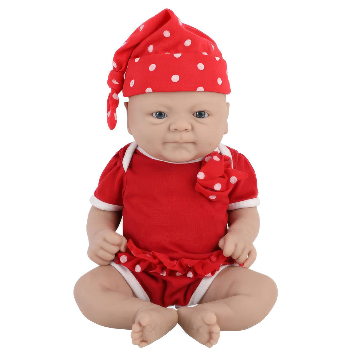 Baby doll in a red outfit with white polka dots on a white background