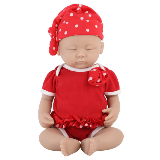 Baby doll wearing a red outfit with white polka dots on a white background